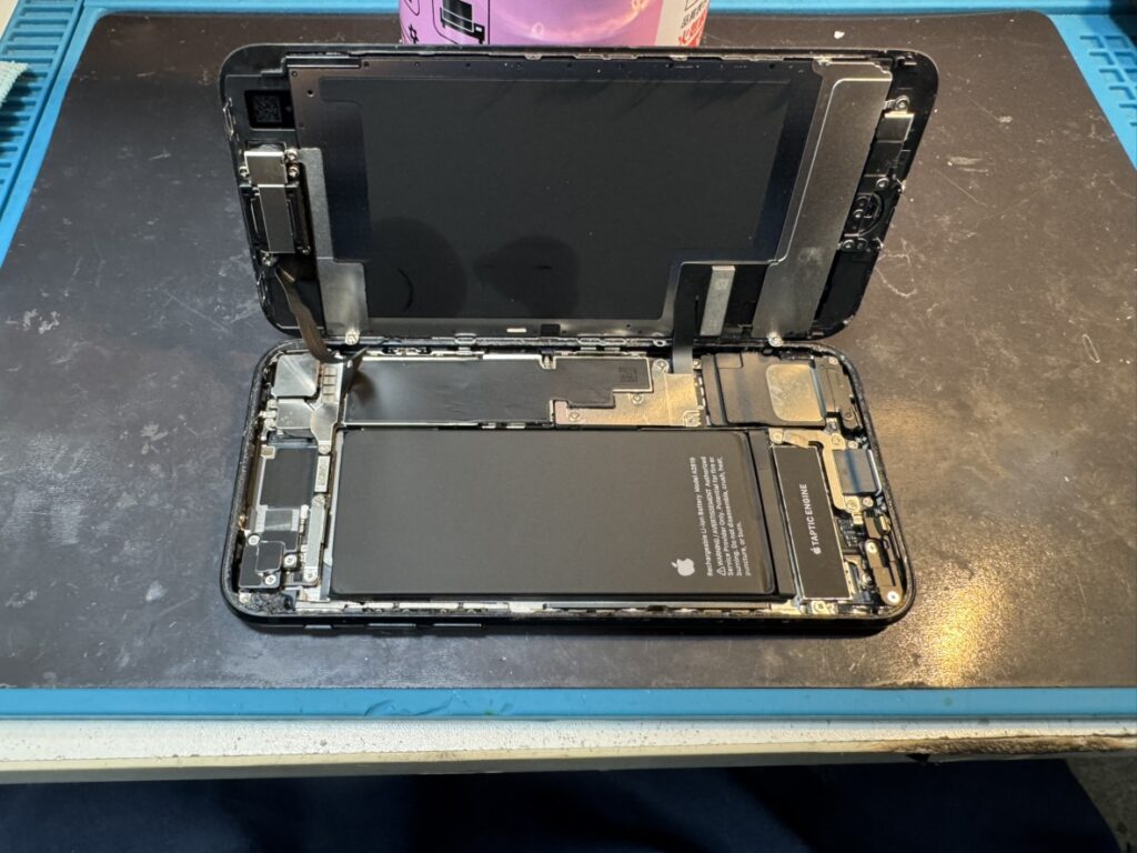 フェニックス横浜関内本店にてiPhone SE3を慎重に開封し電池交換を行う様子