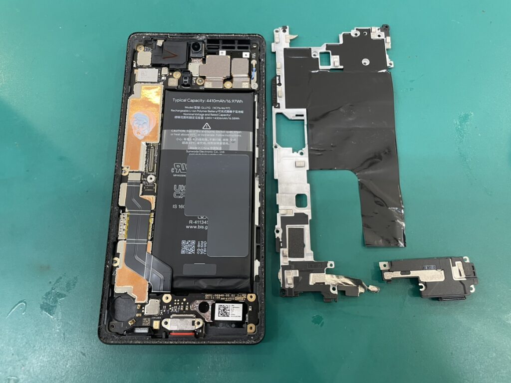 Pixel7aの画面を慎重に開き、強力に接着されたバッテリーを安全に取り外している様子